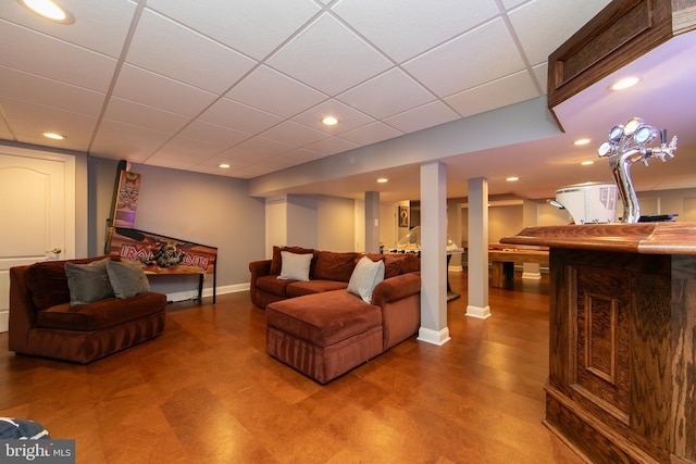 living room featuring a drop ceiling