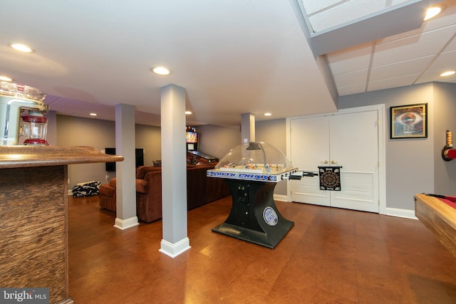 playroom with a paneled ceiling