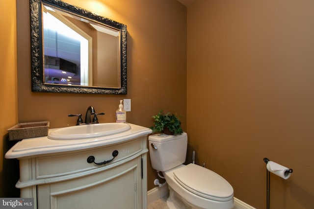 bathroom featuring toilet and vanity