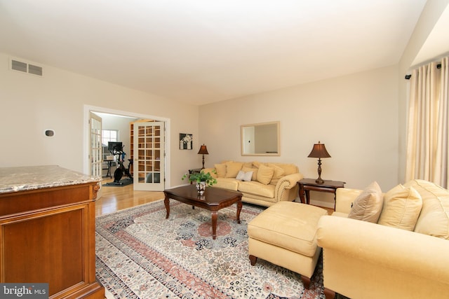 living room featuring french doors and light hardwood / wood-style floors