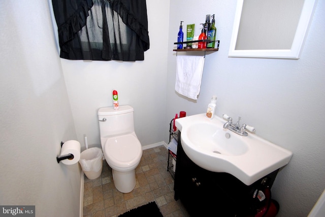 bathroom with toilet and vanity