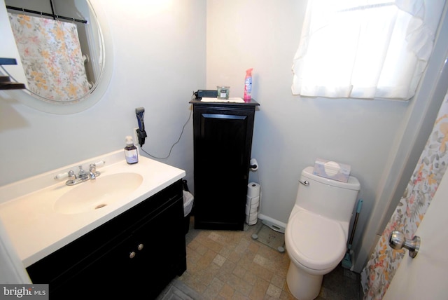 bathroom with toilet and vanity