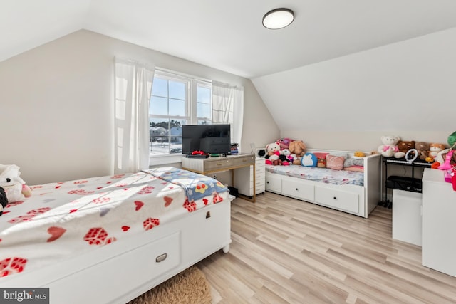 bedroom featuring vaulted ceiling and light hardwood / wood-style floors