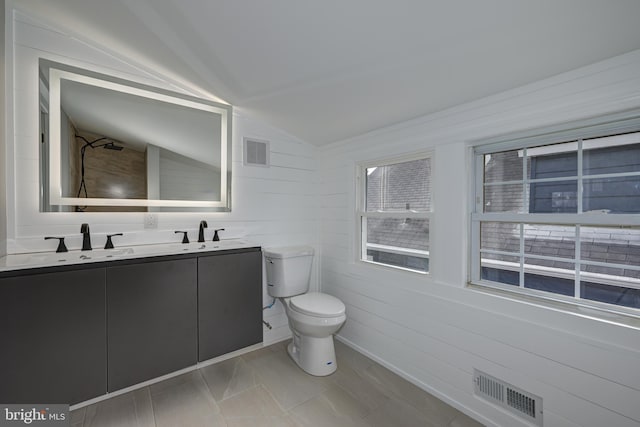 bathroom with toilet, vanity, walk in shower, and vaulted ceiling