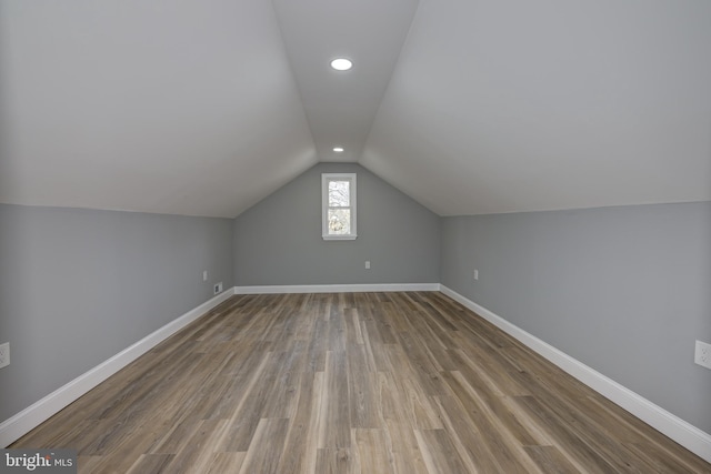 bonus room featuring wood-type flooring and lofted ceiling