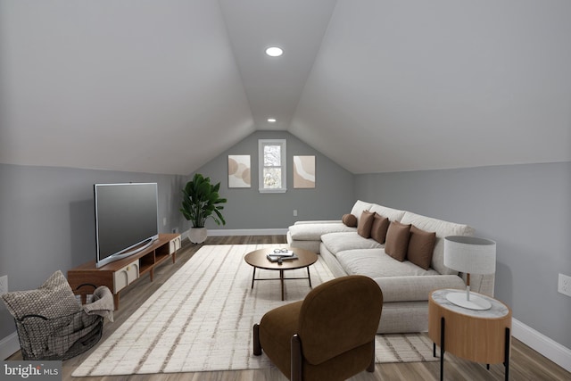 living room featuring vaulted ceiling and wood-type flooring