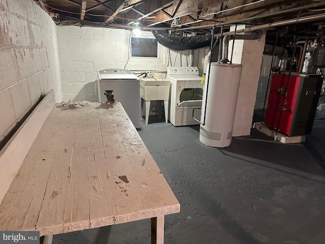 basement featuring water heater and washer and clothes dryer