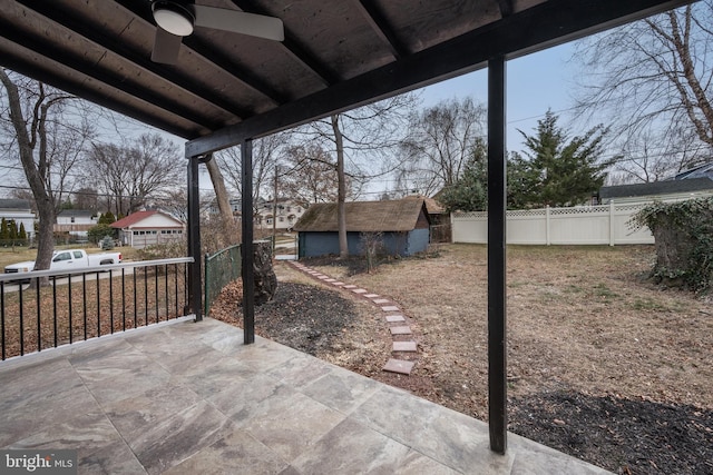 view of patio / terrace with ceiling fan and an outbuilding