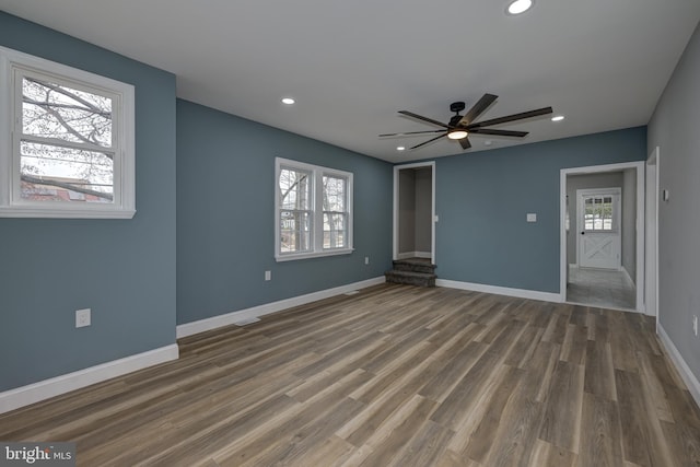 unfurnished room with ceiling fan and dark hardwood / wood-style floors