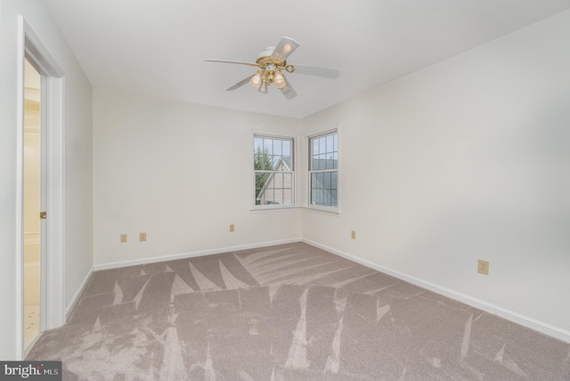 spare room with carpet floors and ceiling fan