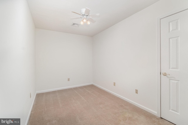 carpeted spare room with ceiling fan