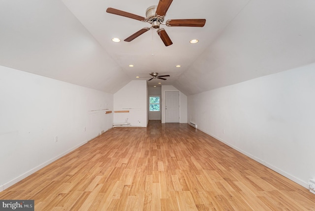 additional living space featuring lofted ceiling and light hardwood / wood-style flooring