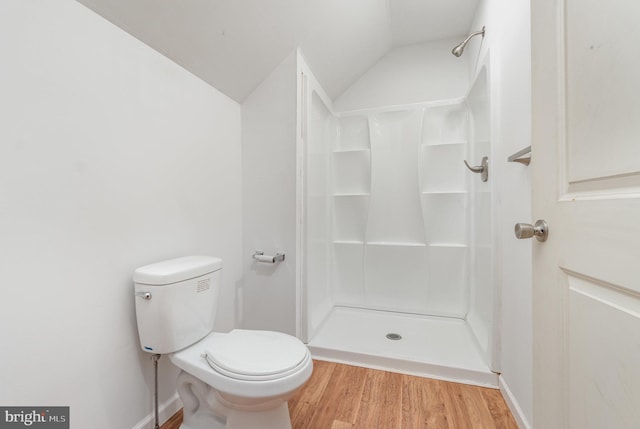 bathroom with toilet, lofted ceiling, hardwood / wood-style flooring, and walk in shower