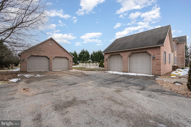 view of side of home with a garage and an outdoor structure