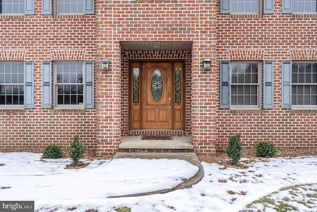 view of snow covered property entrance