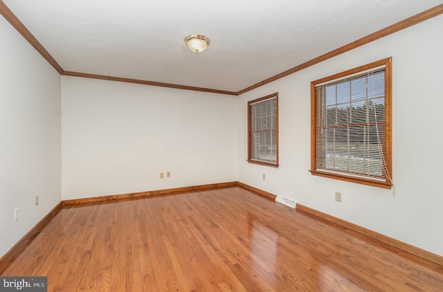 unfurnished room with hardwood / wood-style floors and ornamental molding