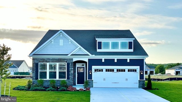 craftsman-style home with a yard and a garage