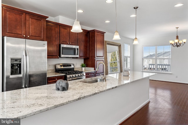 kitchen featuring sink, stainless steel appliances, and hanging light fixtures