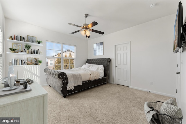 bedroom with ceiling fan and light carpet