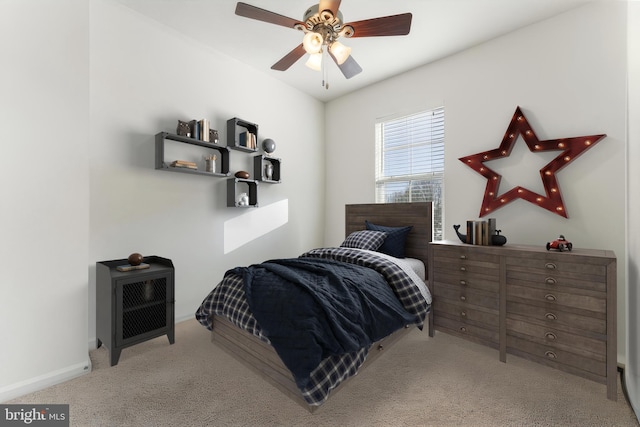 bedroom featuring ceiling fan and light carpet