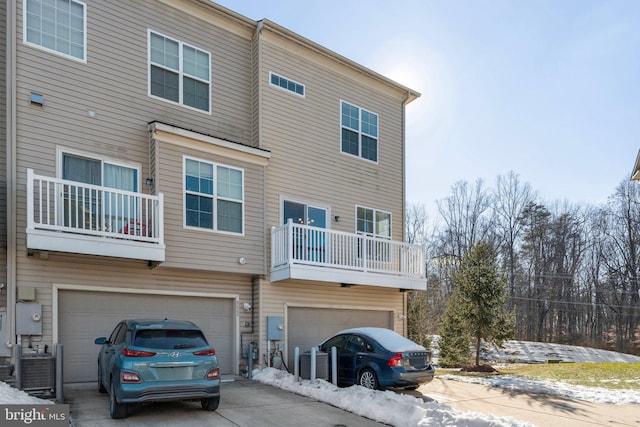 back of house featuring a balcony and a garage