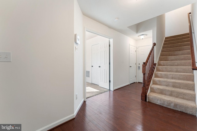 foyer entrance with dark hardwood / wood-style flooring