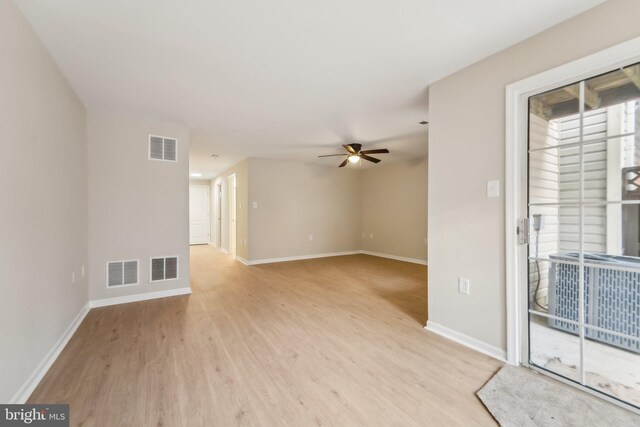 empty room with ceiling fan and light wood-type flooring