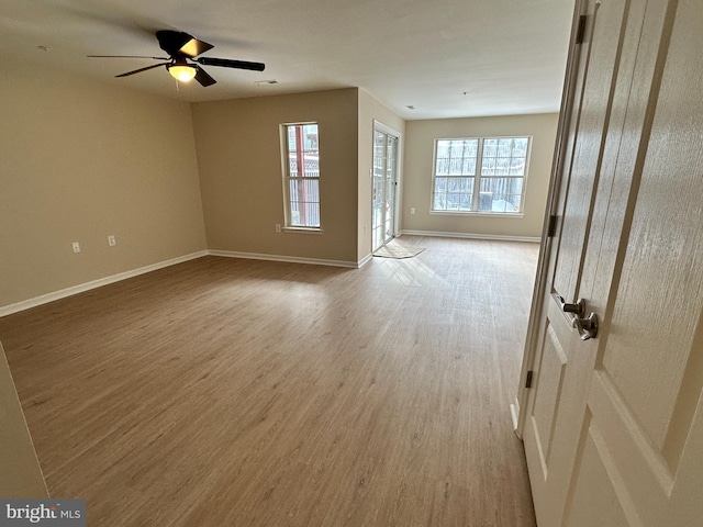 spare room featuring ceiling fan and light hardwood / wood-style flooring