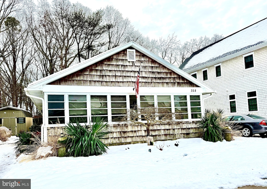 view of snow covered rear of property