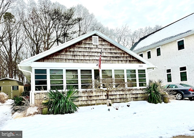 view of snow covered rear of property