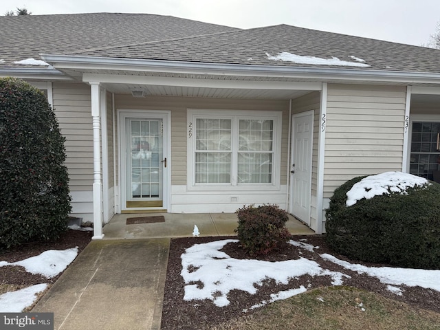 view of snow covered property entrance