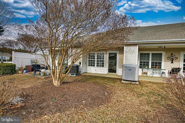 back of house with a patio area, a lawn, and cooling unit