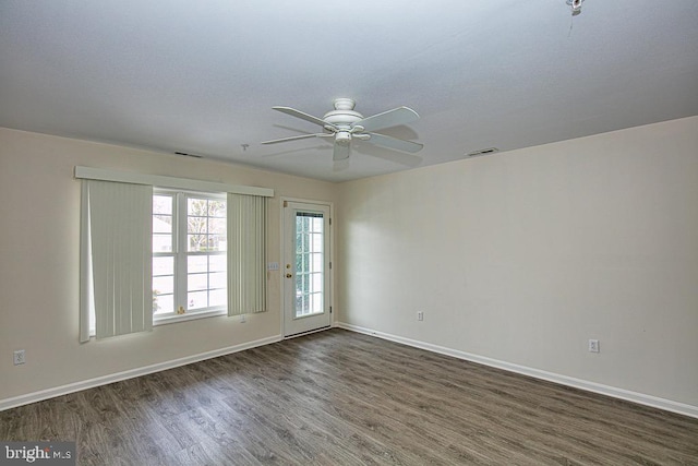 empty room with ceiling fan and dark hardwood / wood-style floors