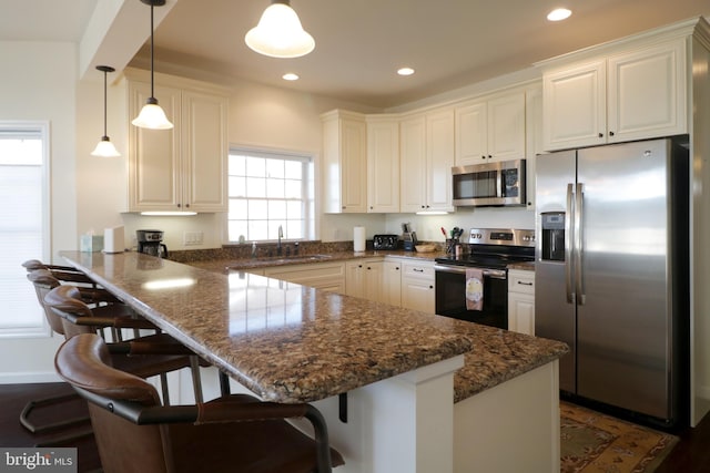 148 Gemstone Dr, Bellefonte, PA 16823 - kitchen featuring a sink, a peninsula, stainless steel appliances, white cabinets, and recessed lighting