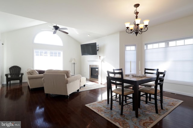 148 Gemstone Dr, Bellefonte, PA 16823 - dining room with baseboards, a fireplace, dark wood-type flooring, ceiling fan with notable chandelier, and vaulted ceiling