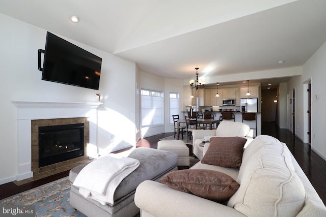 148 Gemstone Dr, Bellefonte, PA 16823 - living room featuring dark wood-style flooring, baseboards, recessed lighting, a tiled fireplace, and a notable chandelier