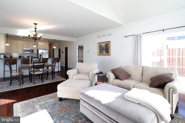 148 Gemstone Dr, Bellefonte, PA 16823 - living area with an inviting chandelier, dark wood-style floors, lofted ceiling, and visible vents