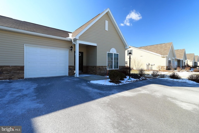 148 Gemstone Dr, Bellefonte, PA 16823 - view of front of property featuring stone siding, driveway, and an attached garage