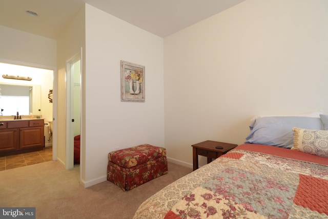 148 Gemstone Dr, Bellefonte, PA 16823 - bedroom featuring baseboards, ensuite bathroom, a sink, and light carpet