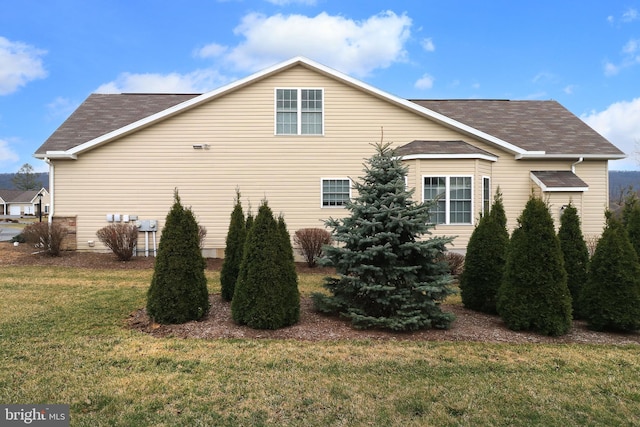 148 Gemstone Dr, Bellefonte, PA 16823 - view of home's exterior featuring roof with shingles and a lawn