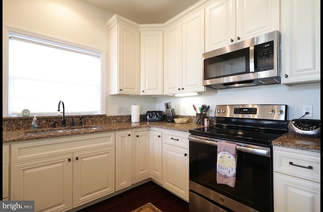 148 Gemstone Dr, Bellefonte, PA 16823 - kitchen featuring a sink, white cabinetry, dark stone countertops, and appliances with stainless steel finishes