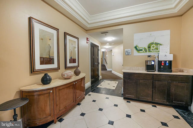 corridor with ornamental molding, visible vents, baseboards, and stairs