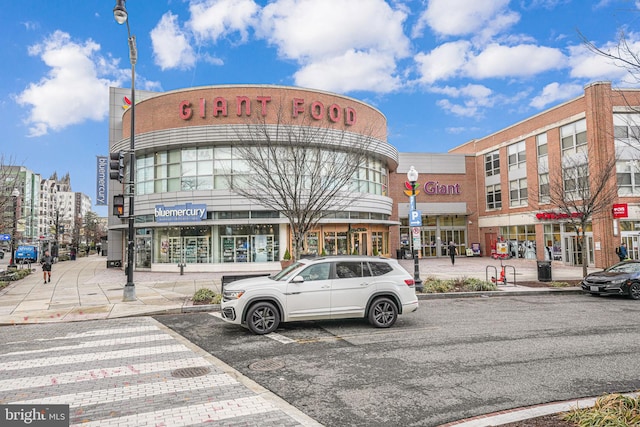 view of property with uncovered parking and a city view