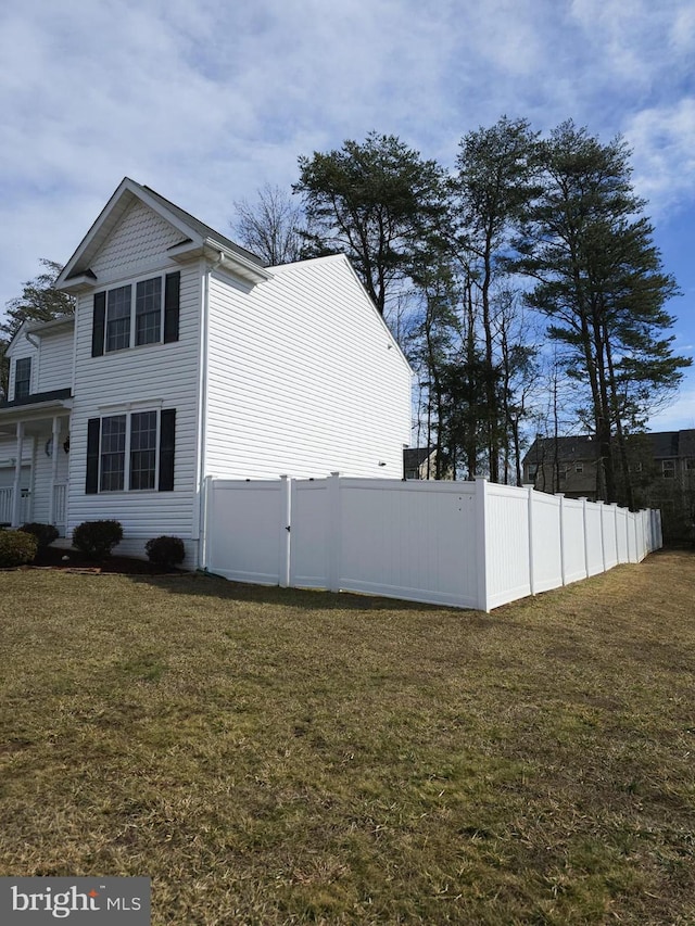 view of side of home with a lawn