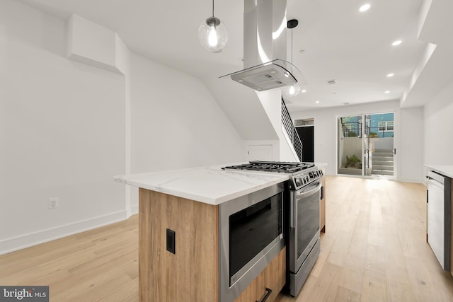 kitchen featuring stainless steel range with gas stovetop, island exhaust hood, hanging light fixtures, light stone countertops, and a center island