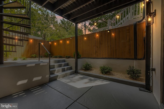 view of patio terrace at dusk