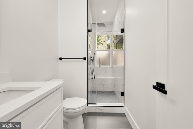 bathroom with tile patterned floors, toilet, walk in shower, and vanity