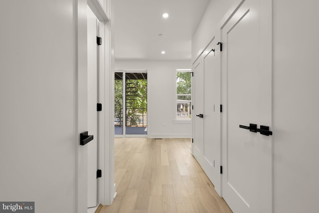 corridor with light hardwood / wood-style flooring