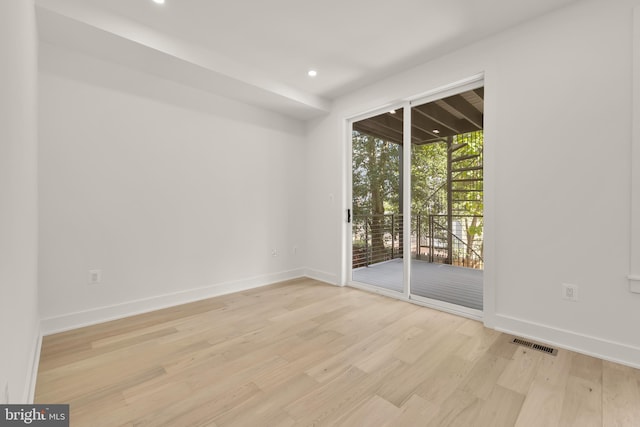 spare room with light hardwood / wood-style flooring