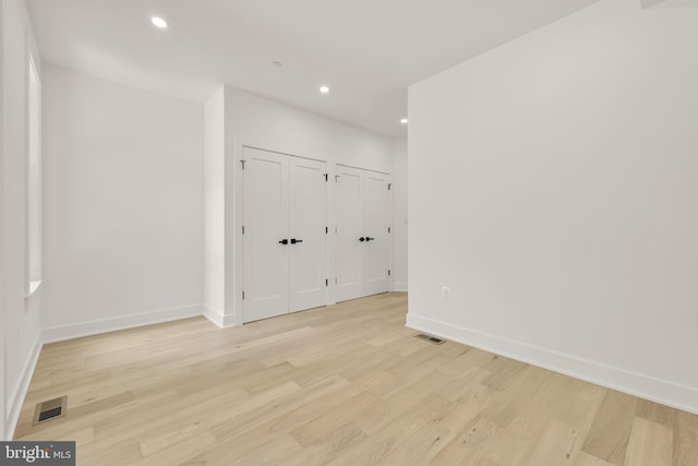 unfurnished room with light hardwood / wood-style flooring